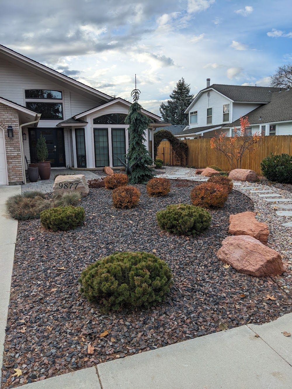 Front-yard hardscape with decorative rock and plantings — Green Lawn Care portfolio photo
